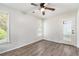 Cozy bedroom with wood-look flooring and ample natural light at 703 Kirkwood Cir, Woodstock, GA 30189