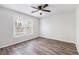 Bedroom featuring hard surface floors, ceiling fan and a window for natural light at 703 Kirkwood Cir, Woodstock, GA 30189