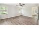Bedroom with wood-look floors, two windows, and neutral paint at 703 Kirkwood Cir, Woodstock, GA 30189