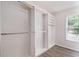 Walk-in closet with custom shelving, racks and a window that provides natural light at 703 Kirkwood Cir, Woodstock, GA 30189