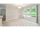 Bright dining area featuring large windows with outdoor view and neutral tile floors at 703 Kirkwood Cir, Woodstock, GA 30189