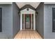 Inviting front entrance with a wood door, side lights, and decorative tile, enhancing curb appeal at 703 Kirkwood Cir, Woodstock, GA 30189