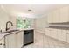 Kitchen area with stainless steel appliances, ample cabinetry, and view to outside at 703 Kirkwood Cir, Woodstock, GA 30189