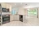 Kitchen area with stainless steel appliances, ample cabinetry, and a view of the dining area at 703 Kirkwood Cir, Woodstock, GA 30189