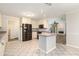 Spacious kitchen featuring stainless appliances, island, and white cabinets at 703 Kirkwood Cir, Woodstock, GA 30189