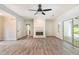 Open living space featuring modern flooring, a fireplace, and access to the patio, creating an airy atmosphere at 703 Kirkwood Cir, Woodstock, GA 30189