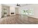 Spacious living room with modern flooring, a fireplace, and sliding doors to the back, perfect for relaxing at 703 Kirkwood Cir, Woodstock, GA 30189