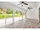 Bright sun room featuring wood-look floors, ceiling fans and access to the outdoors at 703 Kirkwood Cir, Woodstock, GA 30189