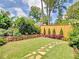 Landscaped backyard with stone path, privacy fence and trimmed evergreen bushes at 192 Chicopee Dr, Marietta, GA 30060