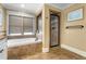 Well-lit bathroom showcasing a tub, shower, and tiled floor at 192 Chicopee Dr, Marietta, GA 30060