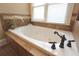 Close-up of a tiled tub with an elegant faucet fixture at 192 Chicopee Dr, Marietta, GA 30060