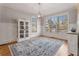 Dining room with large windows, hardwood floors, and built-in display cabinet at 192 Chicopee Dr, Marietta, GA 30060