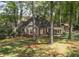 A quaint brick home surrounded by mature trees and lush greenery at 192 Chicopee Dr, Marietta, GA 30060