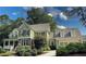 Beautifully landscaped home with green siding, brick accents, and a well-maintained lawn under a partly cloudy sky at 192 Chicopee Dr, Marietta, GA 30060
