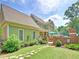 Green two-story house with beautiful back yard, patio with table, and chairs at 192 Chicopee Dr, Marietta, GA 30060
