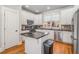 Well-lit kitchen featuring an island, stainless steel appliances, and ample cabinet space at 192 Chicopee Dr, Marietta, GA 30060