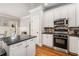 Kitchen with white cabinets, stainless steel appliances and black countertops at 192 Chicopee Dr, Marietta, GA 30060