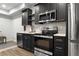 Basement kitchen with sleek black cabinets and stainless steel appliances at 192 Chicopee Dr, Marietta, GA 30060