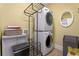 Well-lit laundry area equipped with stacked washer and dryer at 192 Chicopee Dr, Marietta, GA 30060