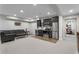 Basement living room with stylish black kitchen, stainless appliances, and plush gray carpeting at 192 Chicopee Dr, Marietta, GA 30060