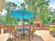 Outdoor patio with stone flooring, table, chairs, an umbrella, and a brick fireplace at 192 Chicopee Dr, Marietta, GA 30060