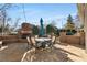 Backyard patio with brick fireplace, stone pavers and a dining set with a blue umbrella at 192 Chicopee Dr, Marietta, GA 30060