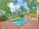 Backyard pool with wooden deck and beautiful landscaping at 192 Chicopee Dr, Marietta, GA 30060
