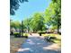 Picturesque town park with lush greenery, walking paths, and benches under a clear sky at 192 Chicopee Dr, Marietta, GA 30060