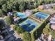Aerial view of community amenities including a pool, tennis courts, and surrounding greenery at 2303 Waters Edge Trl, Roswell, GA 30075