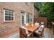 Backyard wooden deck featuring outdoor seating, lush landscaping, and brick exterior home at 2303 Waters Edge Trl, Roswell, GA 30075