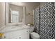 Bright bathroom with a vanity, decorative mirror, and patterned shower curtain at 2303 Waters Edge Trl, Roswell, GA 30075