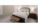 Comfortable bedroom with a padded bench and bedside tables at 2303 Waters Edge Trl, Roswell, GA 30075