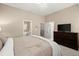 Bedroom with a large bed, dresser, and view into the attached bathroom at 2303 Waters Edge Trl, Roswell, GA 30075