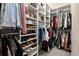 Organized walk-in closet with shelving for shoes, clothes, and accessories at 2303 Waters Edge Trl, Roswell, GA 30075