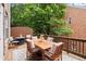 Cozy outdoor deck featuring a dining table and seating, surrounded by lush greenery at 2303 Waters Edge Trl, Roswell, GA 30075