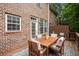 Outdoor deck area with dining table and chairs, set against a brick building backdrop at 2303 Waters Edge Trl, Roswell, GA 30075