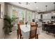 Eat-in kitchen with dining table set near large window, with view of the modern kitchen at 2303 Waters Edge Trl, Roswell, GA 30075