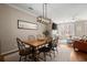 Inviting dining area with hardwood floors and a modern light fixture above the table at 2303 Waters Edge Trl, Roswell, GA 30075
