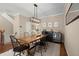 Dining room with stylish lighting fixture, wooden table, and convenient wine storage at 2303 Waters Edge Trl, Roswell, GA 30075