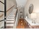 Welcoming entryway with hardwood floors, staircase, and decorative table at 2303 Waters Edge Trl, Roswell, GA 30075