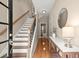 Bright entryway with hardwood floors, staircase, and decorative console table at 2303 Waters Edge Trl, Roswell, GA 30075