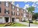 Charming brick townhomes with manicured lawns and black shuttered windows on a sunny day at 2303 Waters Edge Trl, Roswell, GA 30075