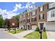 Charming brick townhomes featuring manicured lawns, garages, and inviting curb appeal at 2303 Waters Edge Trl, Roswell, GA 30075