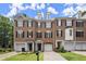 Attractive brick townhouses with well-maintained lawns and symmetrical window designs at 2303 Waters Edge Trl, Roswell, GA 30075