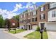 Charming brick townhomes feature manicured lawns, garages, and inviting front entrances at 2303 Waters Edge Trl, Roswell, GA 30075