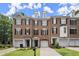 Attractive brick townhomes with symmetrical design, black shutters, and front lawns enhancing curb appeal at 2303 Waters Edge Trl, Roswell, GA 30075
