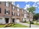 Charming brick townhomes with well-manicured lawns, black shutters, and driveways leading to attached garages at 2303 Waters Edge Trl, Roswell, GA 30075