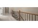 Carpeted upstairs hallway showcasing a decorative wood and metal banister at 2303 Waters Edge Trl, Roswell, GA 30075