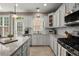 Well-equipped kitchen with white cabinets, stainless steel appliances, and tile backsplash at 2303 Waters Edge Trl, Roswell, GA 30075