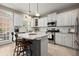 Bright kitchen featuring white cabinets, stainless steel appliances, and granite countertops at 2303 Waters Edge Trl, Roswell, GA 30075